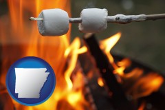 arkansas map icon and roasting marshmallows on a camp fire