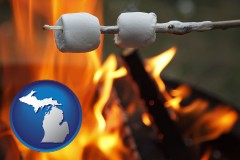 michigan map icon and roasting marshmallows on a camp fire