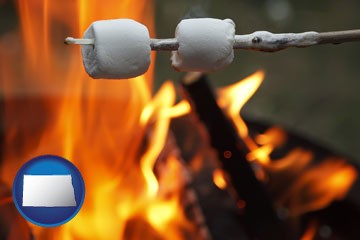 roasting marshmallows on a camp fire - with North Dakota icon