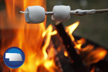 roasting marshmallows on a camp fire - with Nebraska icon