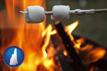 roasting marshmallows on a camp fire - with New Hampshire icon