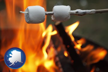 roasting marshmallows on a camp fire - with Alaska icon